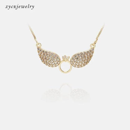 Gold Salty Angel Wings Necklace by Drpshippr featuring detailed angel wing pendant on a delicate chain.