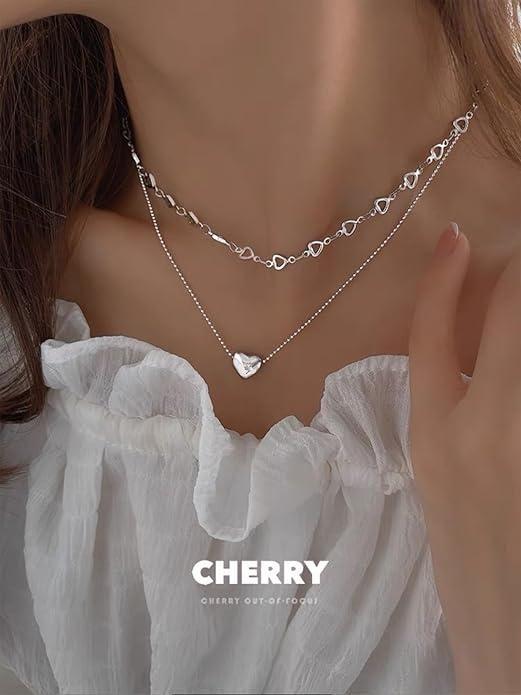 Silver necklace from Salty Falling In Love collection by Drpshippr, featuring a delicate chain and elegant design.