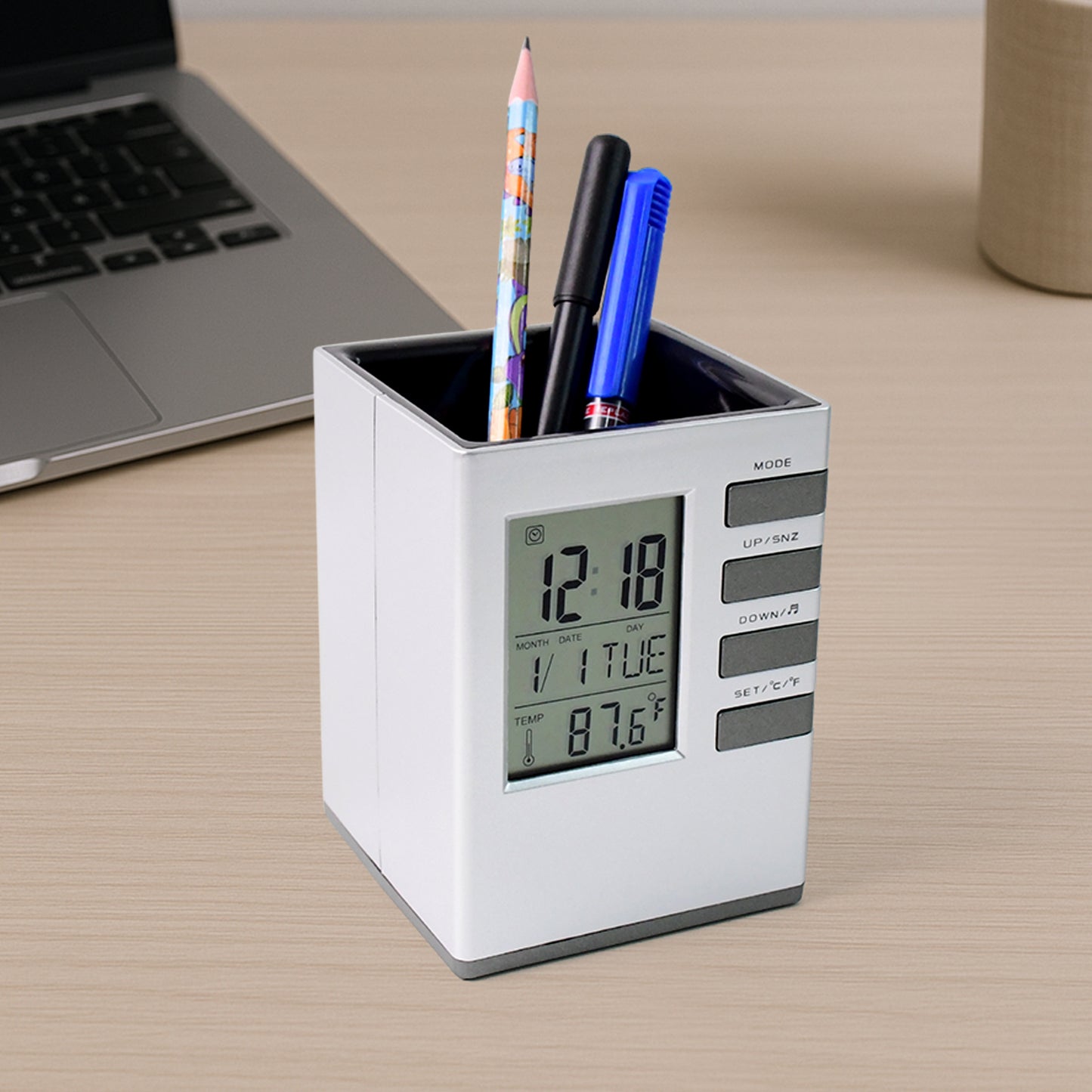 Wukusy multifunction cube digital desk clock with pen holder on office desk, displaying time and organized with pens inside.