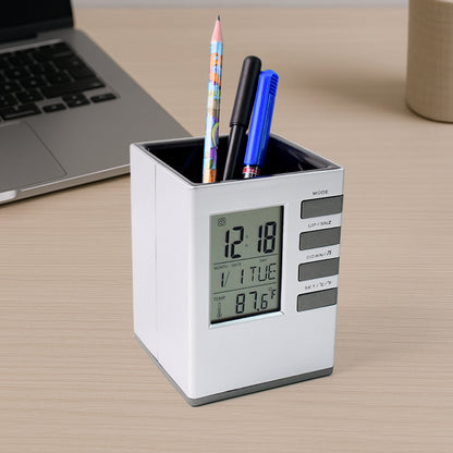 Wukusy multifunction cube digital desk clock with pen holder on office desk, displaying time and organized with pens inside.