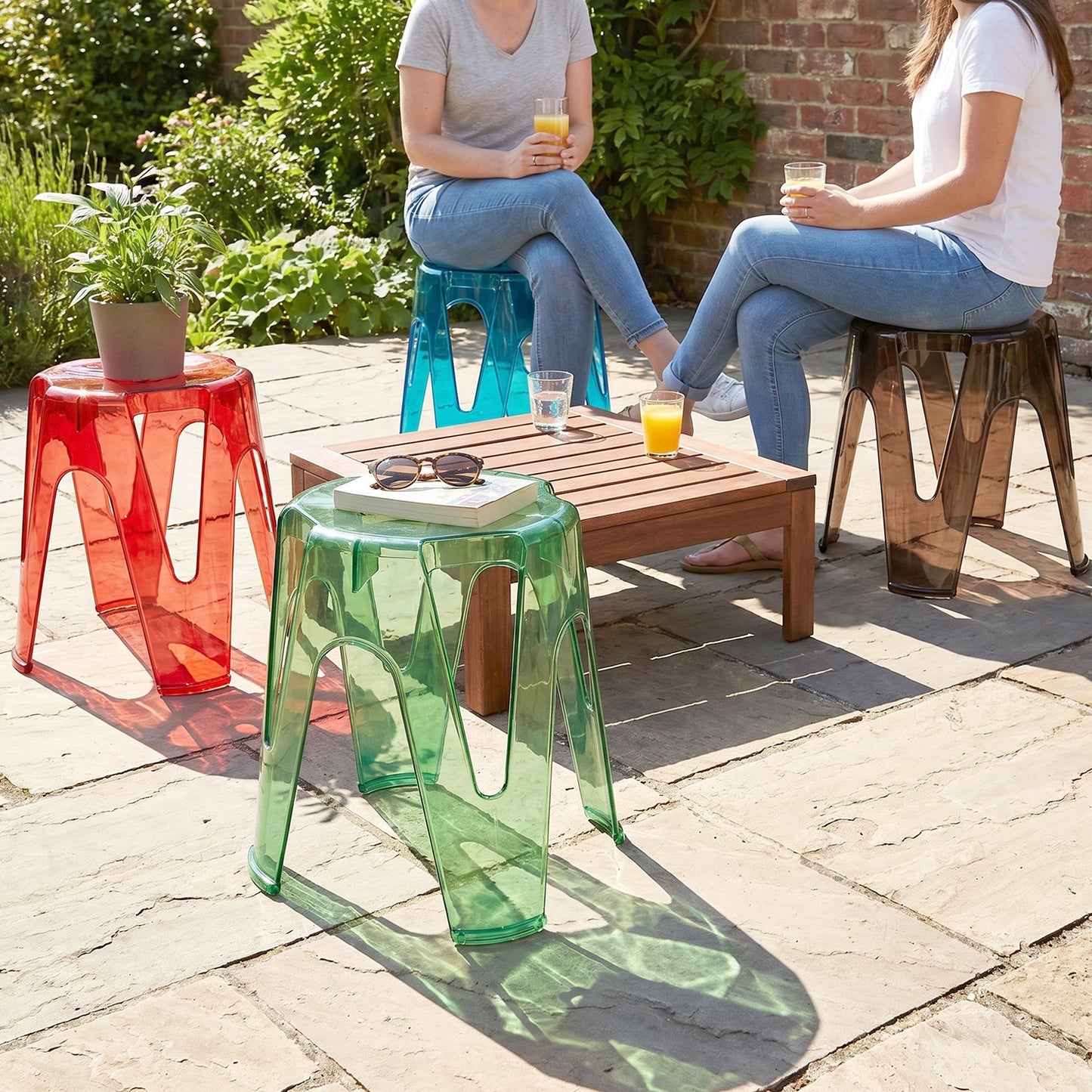 Set of four transparent plastic sitting stools, 28x26cm, sturdy indoor outdoor seats by Wukusy, shown stacked and arranged.