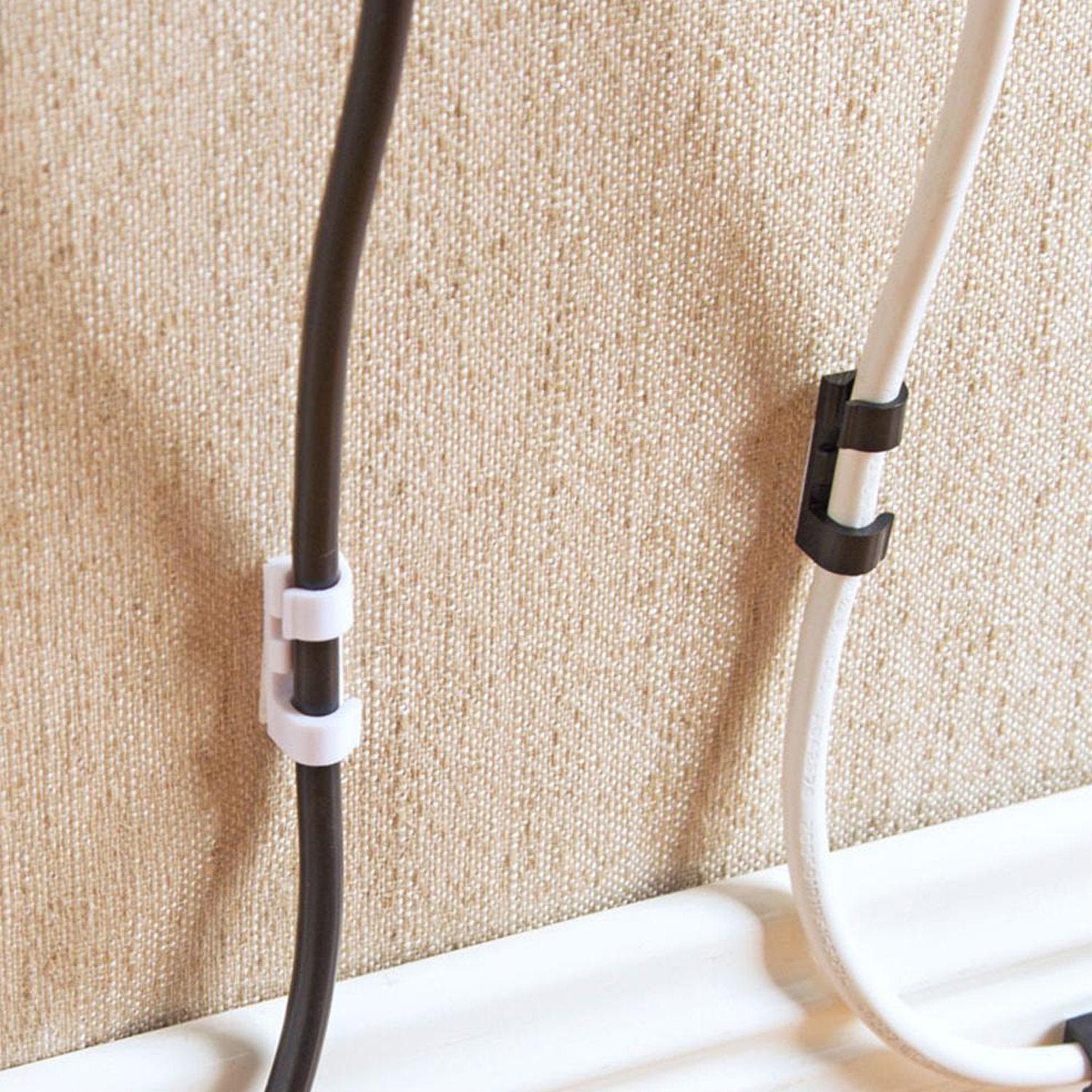 Wukusy 1761 self-adhesive round plastic cable clips for wire management, sticky mount holder for mobile accessories and cords.