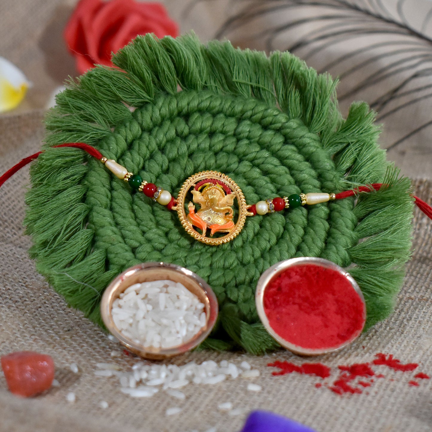 Colorful Ganesha designer Rakhi from Wukusy featuring intricate fashion design and traditional Indian motifs on a vibrant background.