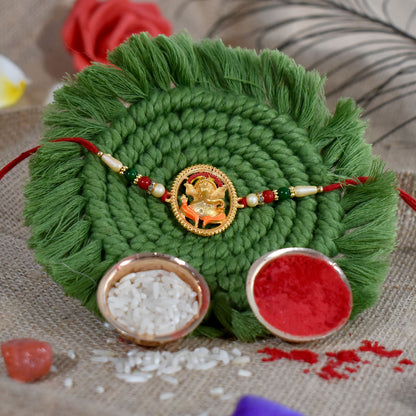 Colorful Ganesha designer Rakhi from Wukusy featuring intricate fashion design and traditional Indian motifs on a vibrant background.