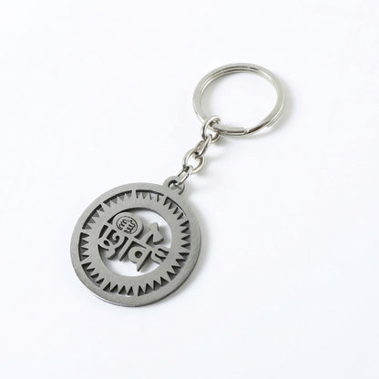Premium metal round Shiv keychain by Wukusy featuring a sleek circular design with engraved detailing.