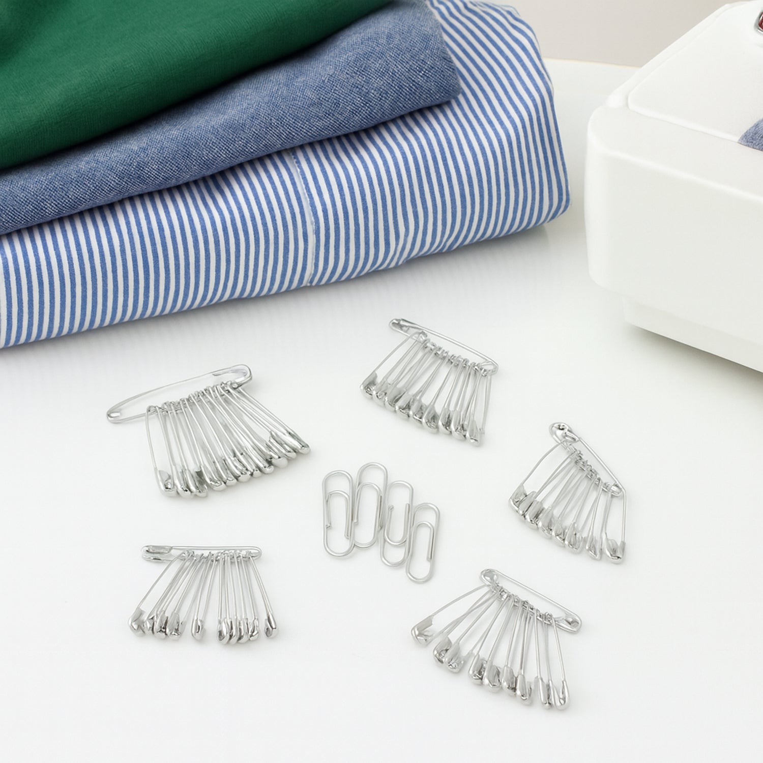 Assorted Wukusy multipurpose metal safety pins in various sizes arranged on a white background.