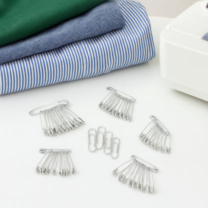 Assorted Wukusy multipurpose metal safety pins in various sizes arranged on a white background.