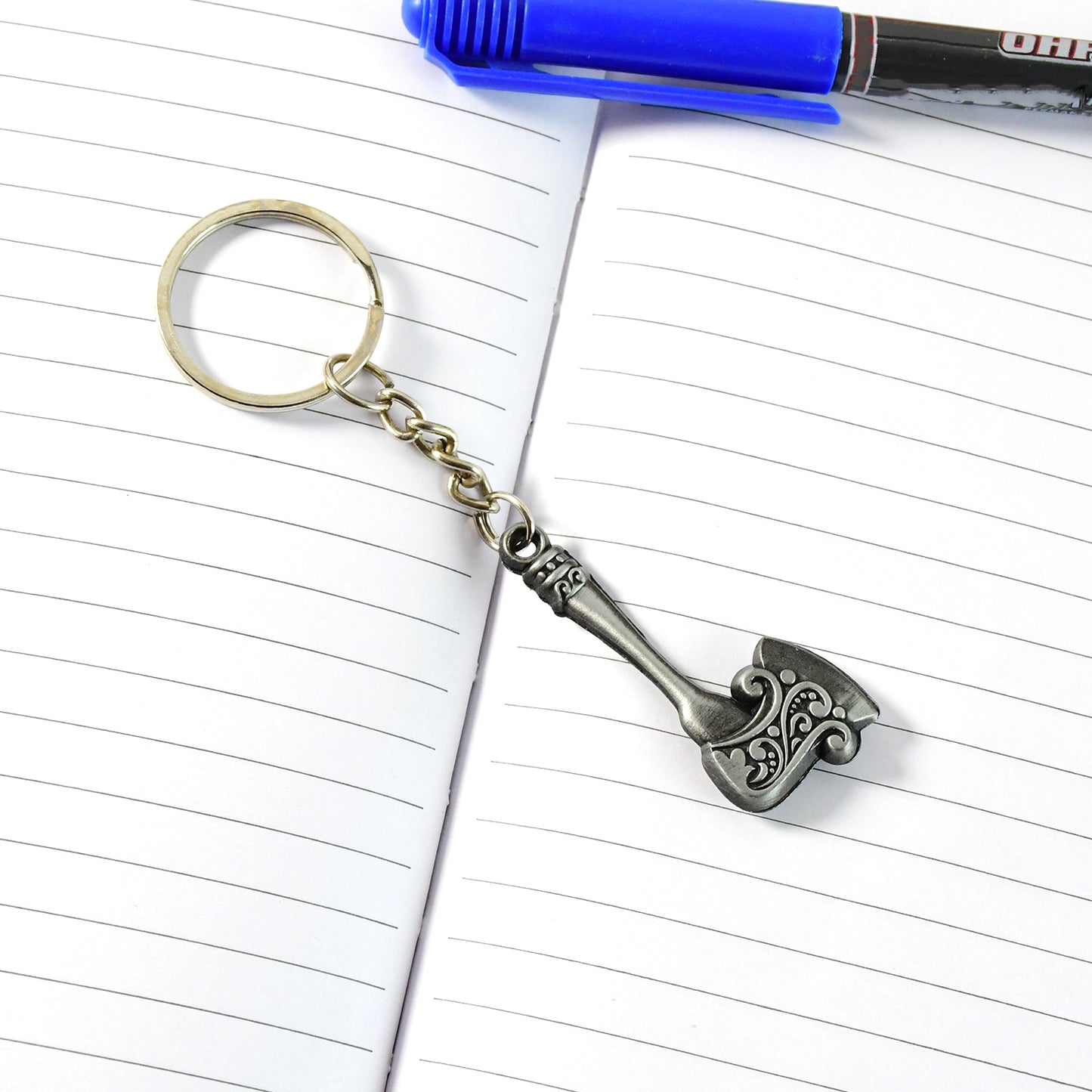 Wukusy stylish axe-shaped metal keychain with intricate details, designed for holding keys and adding a rugged accessory touch.