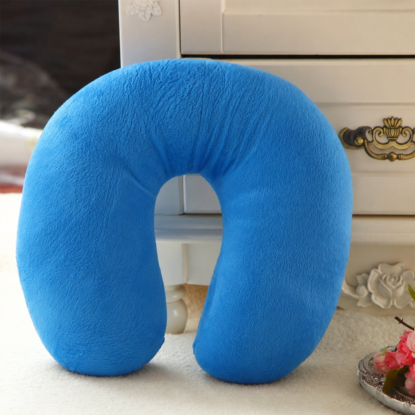 Blue U-shaped Wukusy travel neck pillow with soft support for head and neck comfort while traveling.