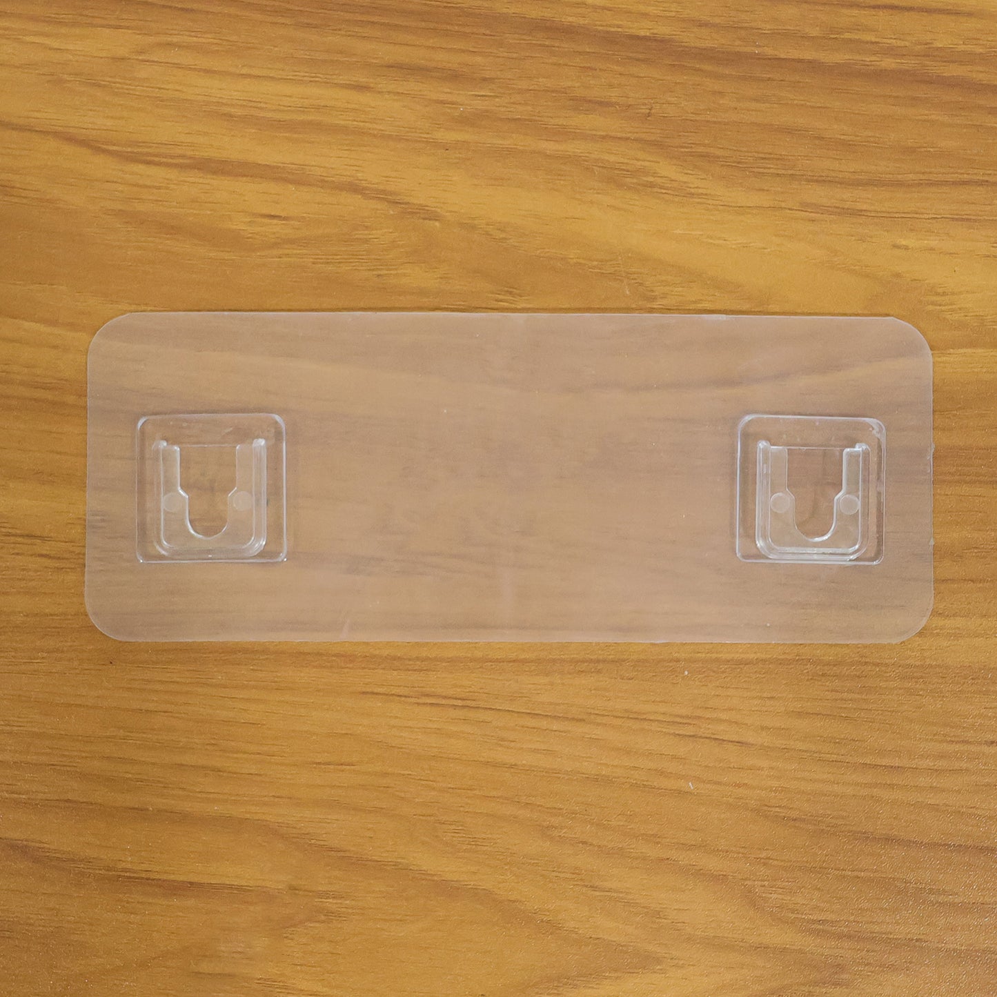 Wall mounted Wukusy self-adhesive hanger for versatile use, shown attached to a surface for hanging items.