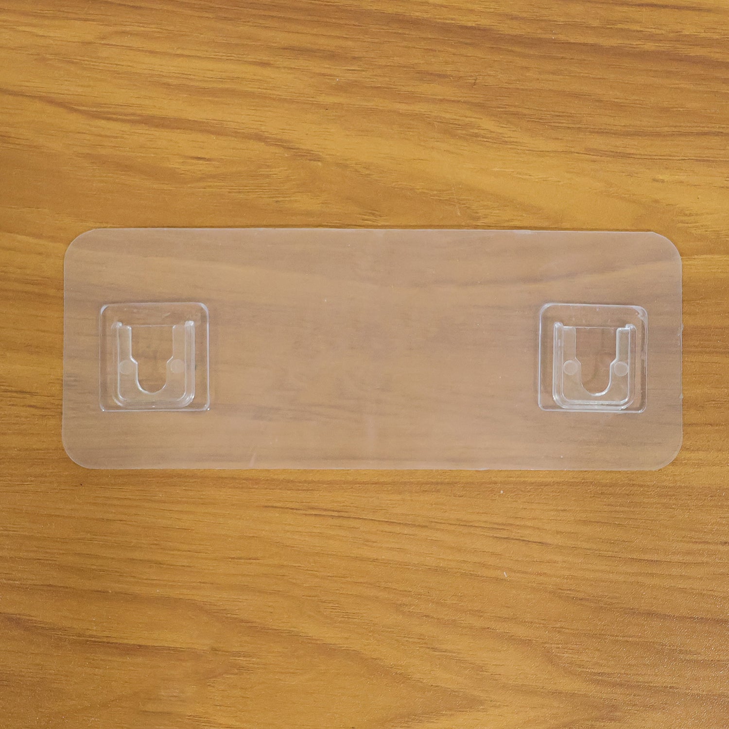 Wall mounted Wukusy self-adhesive hanger for versatile use, shown attached to a surface for hanging items.