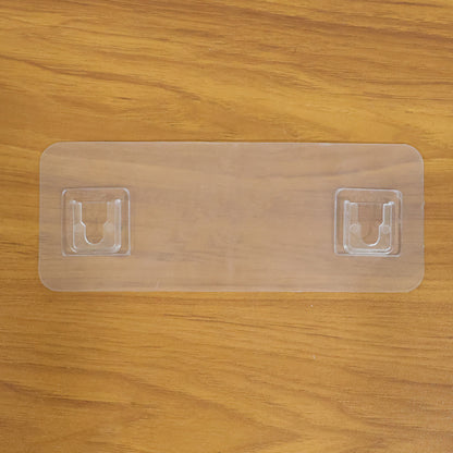 Wall mounted Wukusy self-adhesive hanger for versatile use, shown attached to a surface for hanging items.