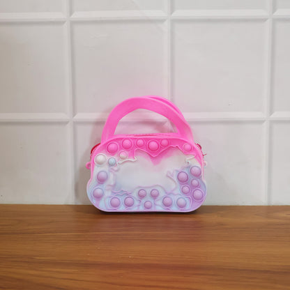 Colorful silicone Pop It coin purse with zipper and handle, designed by Wukusy, featuring a playful bubble sensory fidget toy.
