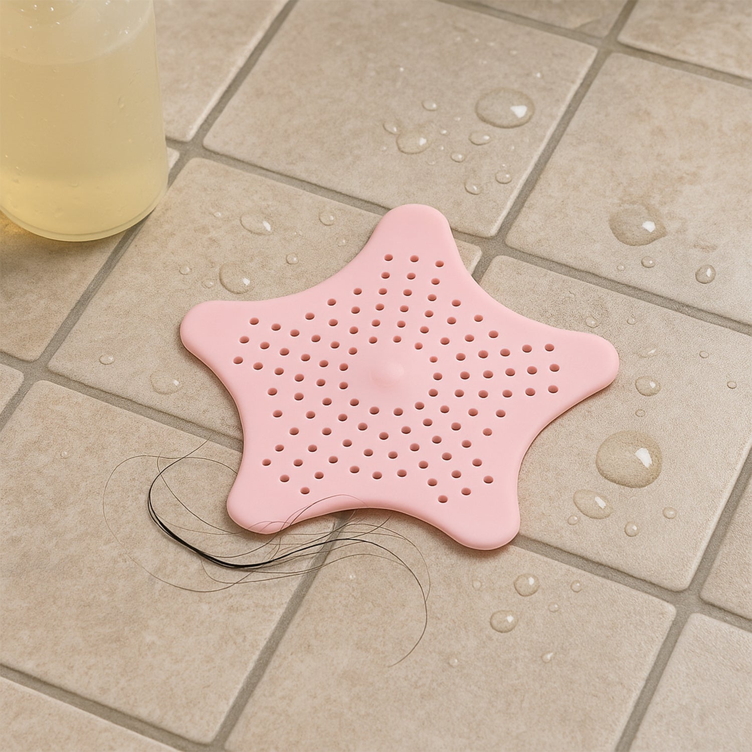 Baby pink silicone star-shaped sink filter by Wukusy, designed to catch hair and debris in bathroom drain strainers.