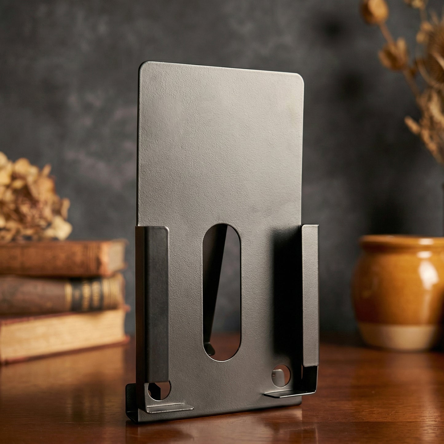 Wukusy Rixa Bracket mobile holder mounted on a surface, adjustable design for secure smartphone support.