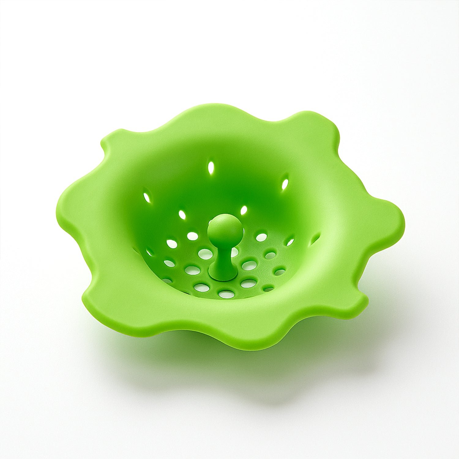 Flexible silicone sink strainer and hair catcher by Wukusy, shown in use over a kitchen drain with water flowing through.