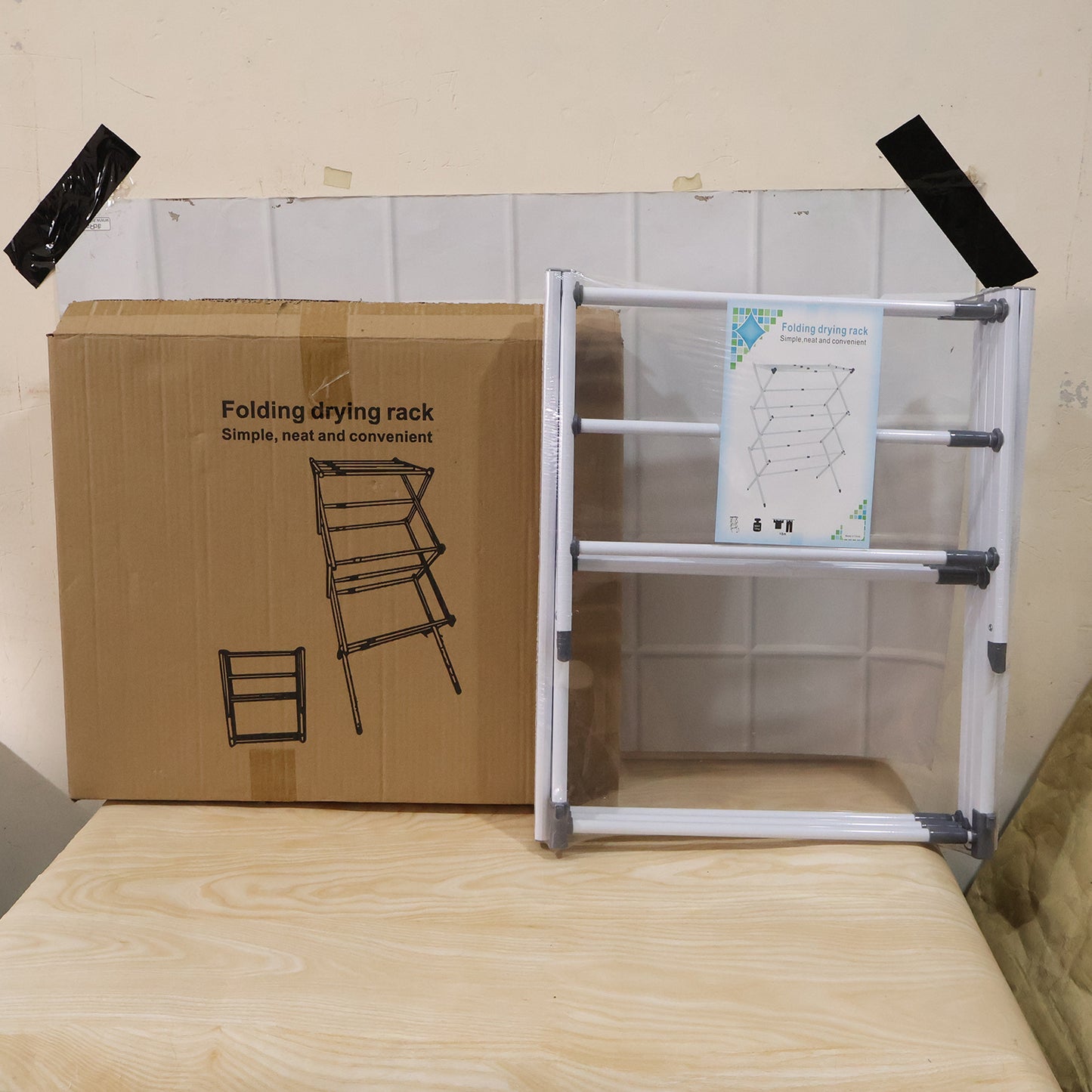 Wukusy 3-tier folding clothes drying rack with multiple bars for laundry, suitable for balcony use, in a compact standing design