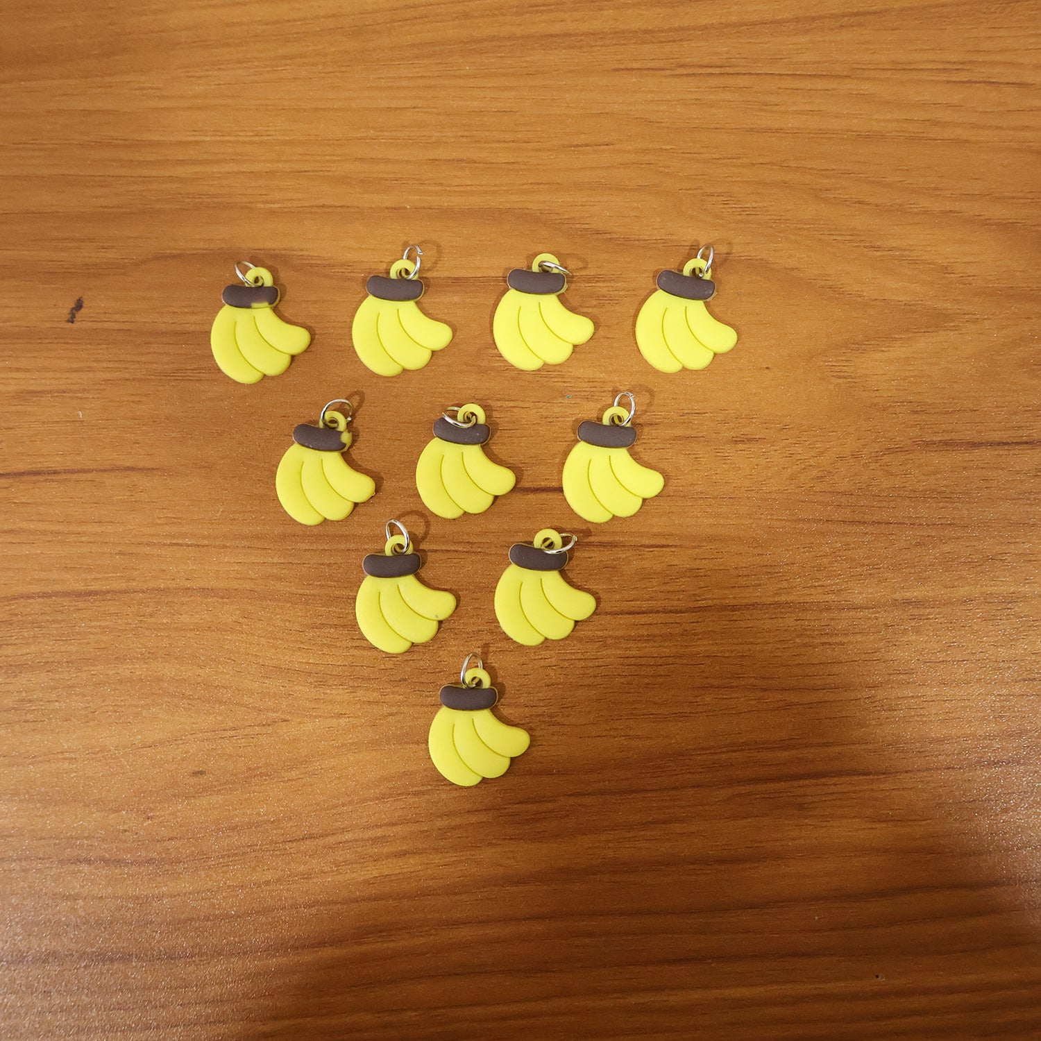 Set of 10 cute banana-shaped bag charm keychains by Wukusy, featuring bright yellow and playful design details.