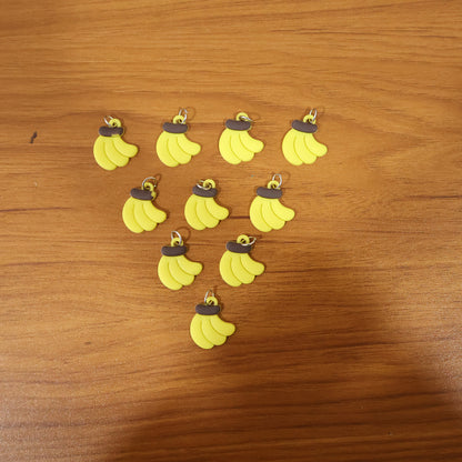 Set of 10 cute banana-shaped bag charm keychains by Wukusy, featuring bright yellow and playful design details.