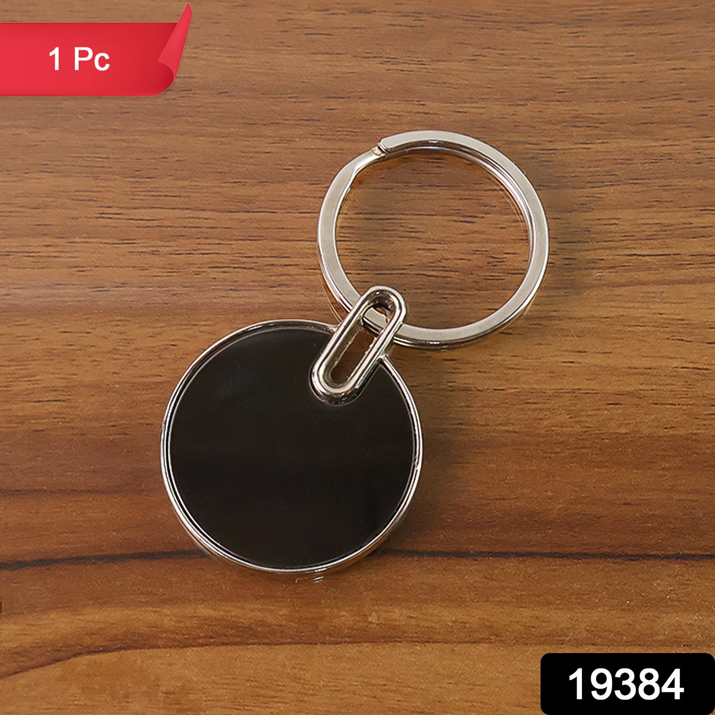 Black round metal keychain from Wukusy, sleek and minimalist design, single piece with shiny finish.