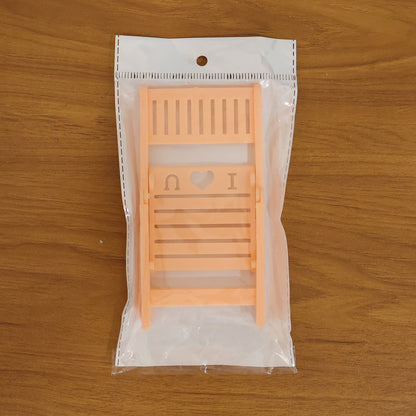 Wukusy mini peach-colored chair-shaped mobile stand holder on a white background, designed to hold smartphones securely.