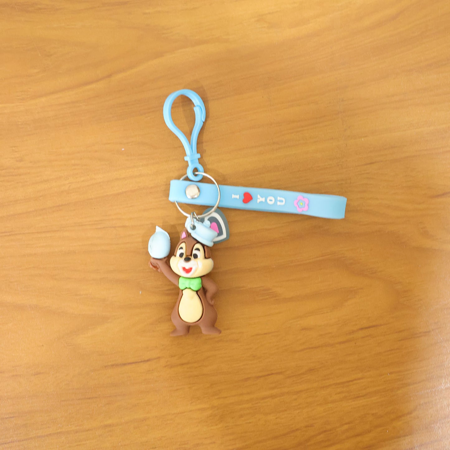 Wukusy cute cartoon squirrel character keychain hanging with detailed squirrel face and colorful design.