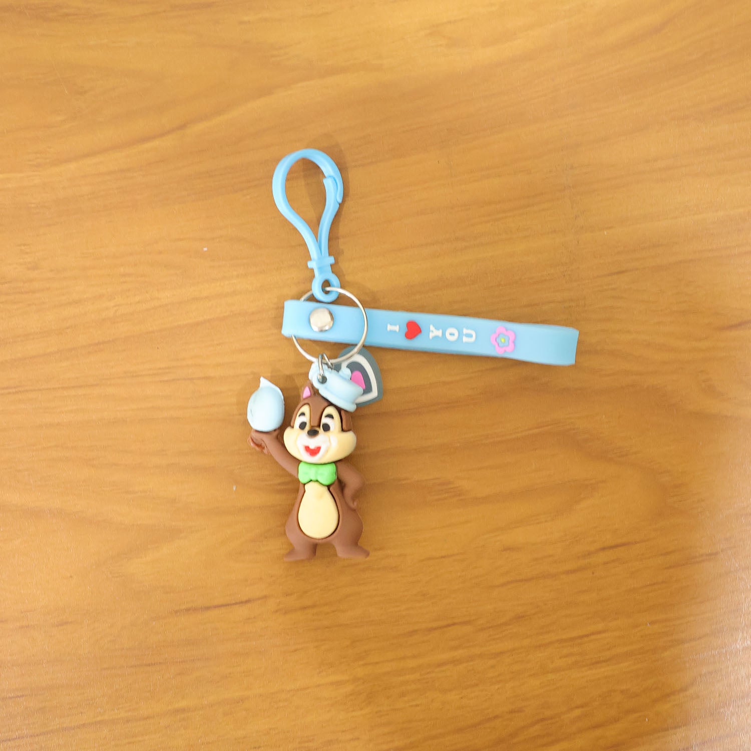 Wukusy cute cartoon squirrel character keychain hanging with detailed squirrel face and colorful design.