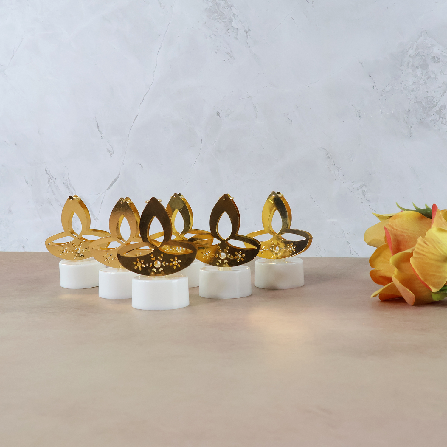Set of six golden diya-shaped LED tealight candles by Wukusy, perfect for home decor and ambient lighting.