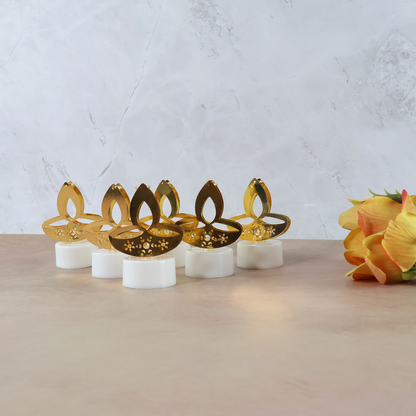 Set of six golden diya-shaped LED tealight candles by Wukusy, perfect for home decor and ambient lighting.