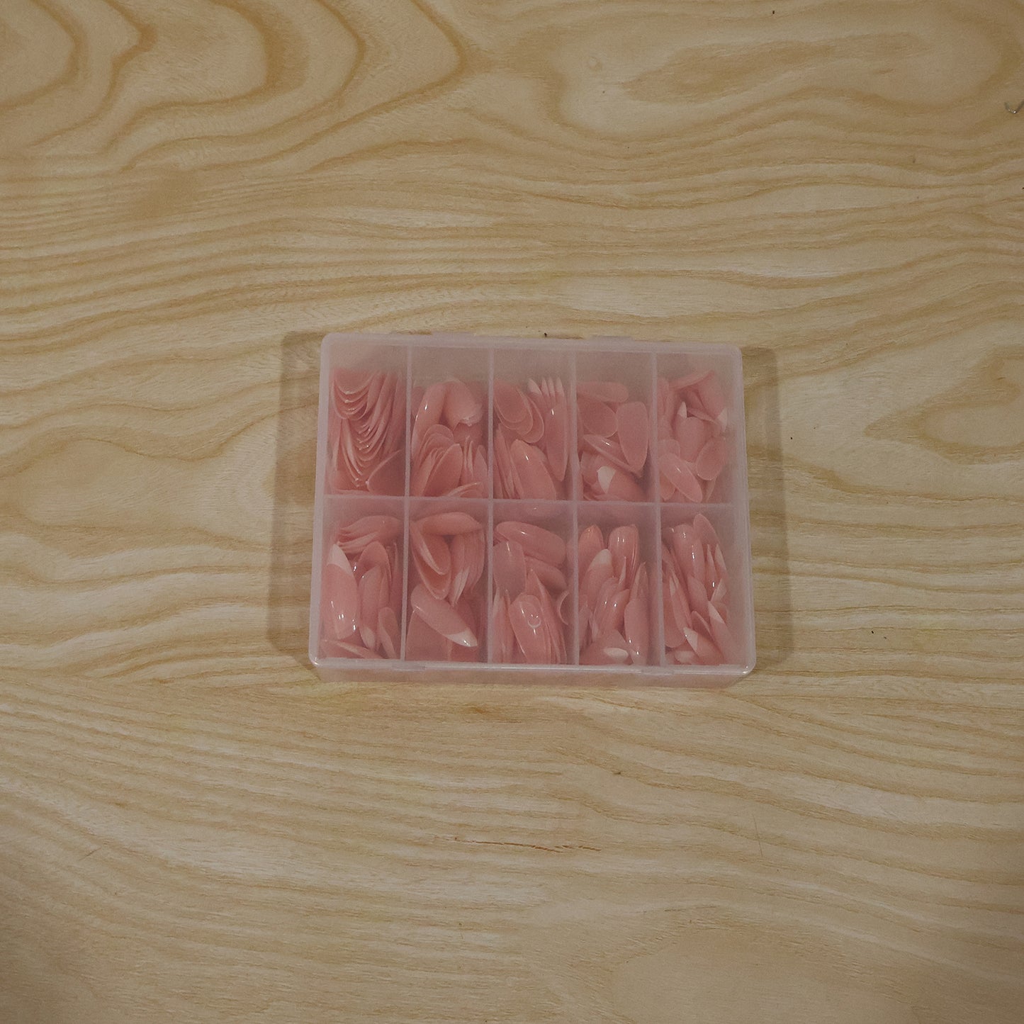 Wukusy artificial nail tips set for salon-style manicures, featuring various nail shapes and lengths on a neutral background.