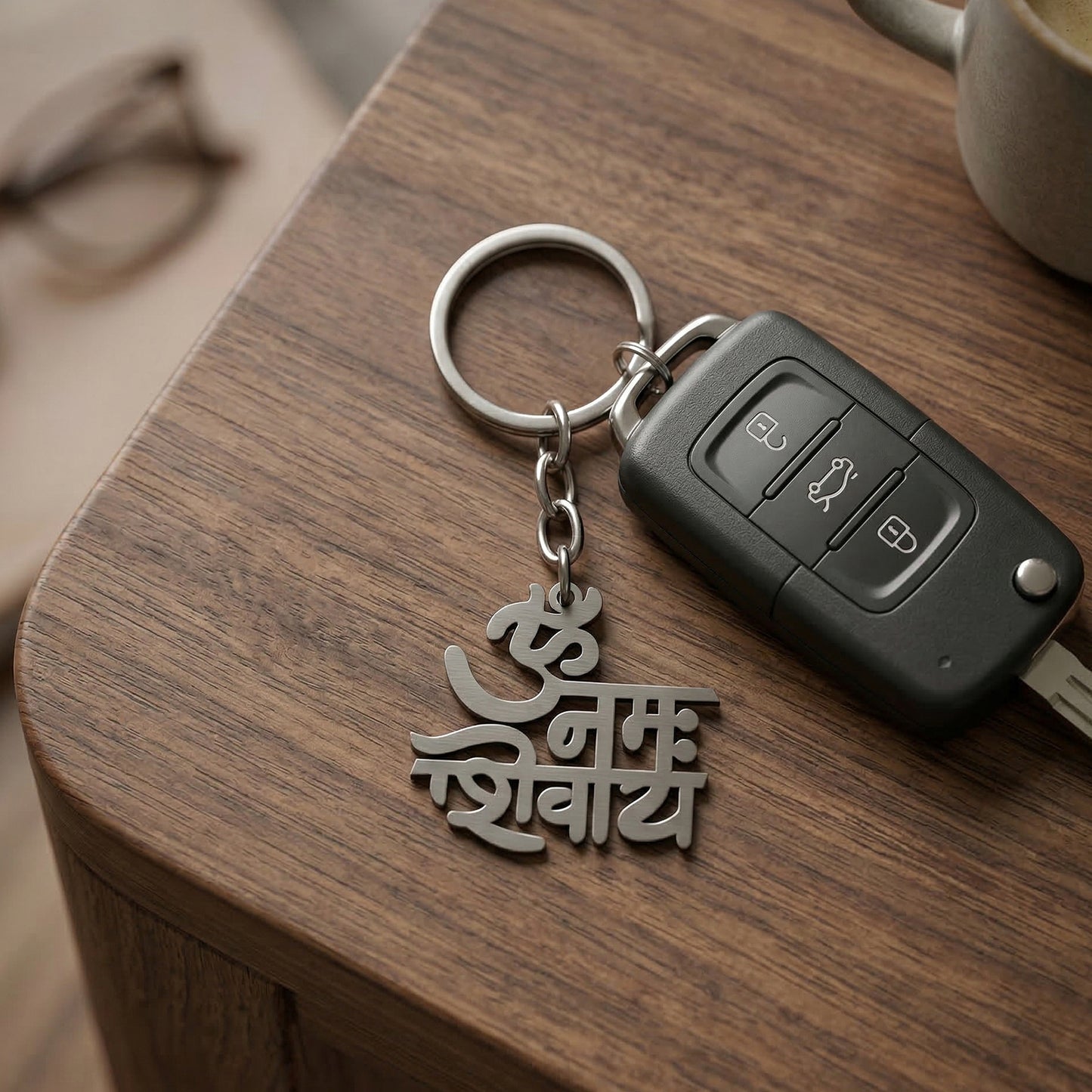 Metal keychain engraved with Om Namah Shivay symbol by Wukusy, featuring intricate design and durable metal material.