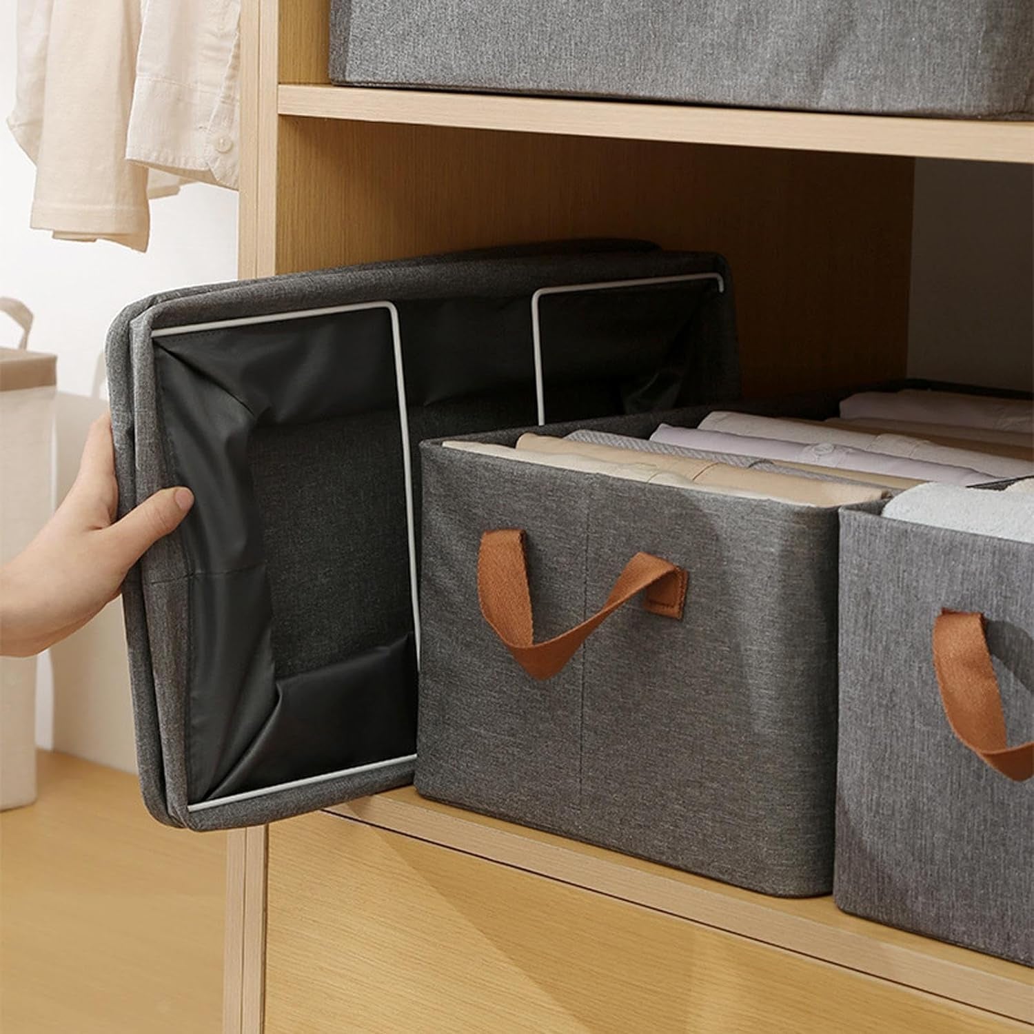 Wukusy foldable cloth storage box with handles, 4728 cm, shown in a home setting with the box open and ready for organizing items.