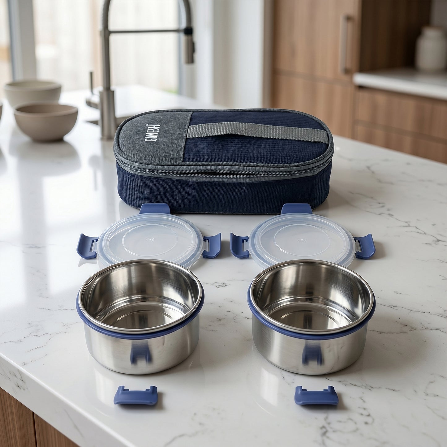 Stainless steel Ganesh Neo Twin 300 lunch box set by Wukusy with two compartments and secure lids, ideal for meals and snacks.