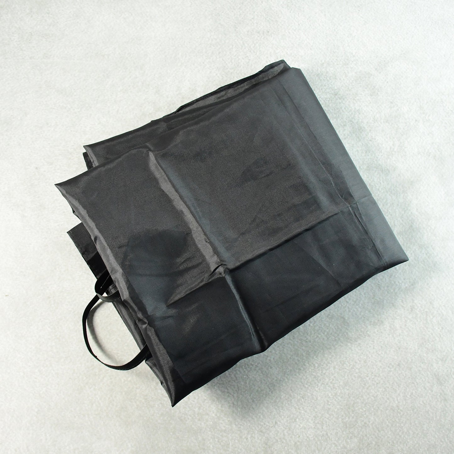 Wukusy barber hair cutting cape draped over a chair, lightweight and waterproof for professional hair salon use.