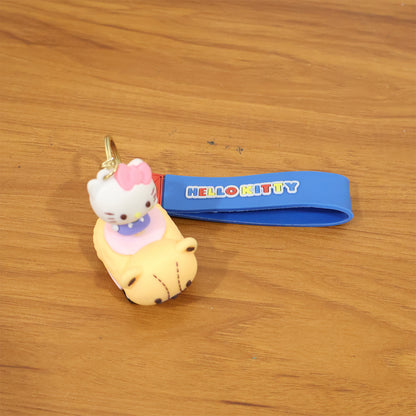 Cute cartoon cat riding toy car silicone keychain by Wukusy, featuring a colorful cat figure on a small vehicle.