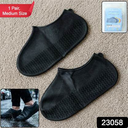 Pair of black waterproof silicone shoe covers by Wukusy, medium size, designed to protect footwear from water and mud.