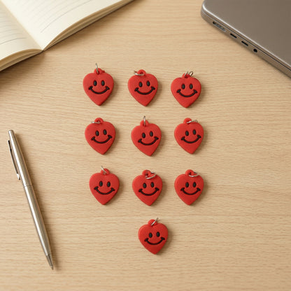 Set of 10 Wukusy smiley heart-shaped bag charm keychains featuring colorful, playful accessories on a white background.
