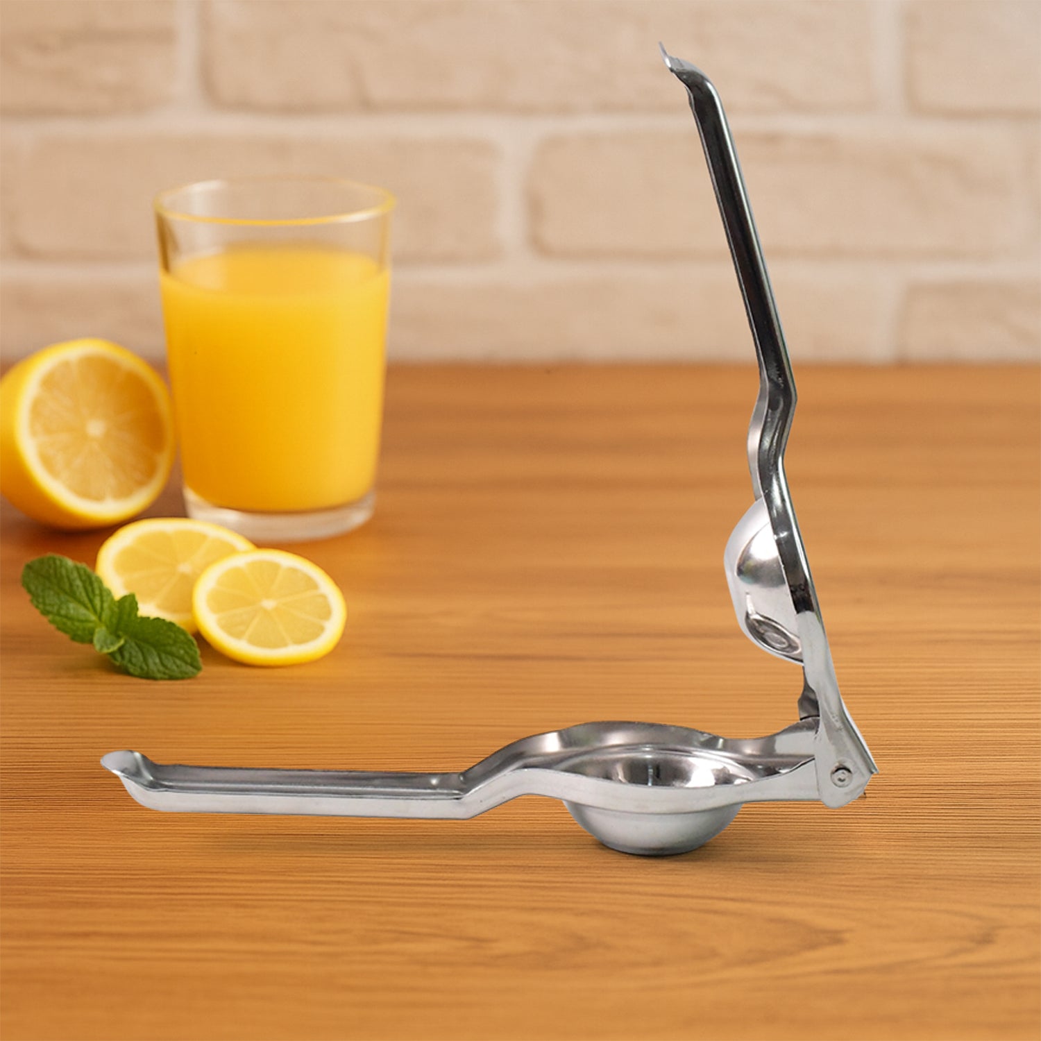 Wukusy Supermom 2-in-1 heavy-duty stainless steel lemon squeezer with built-in bottle opener on a kitchen countertop