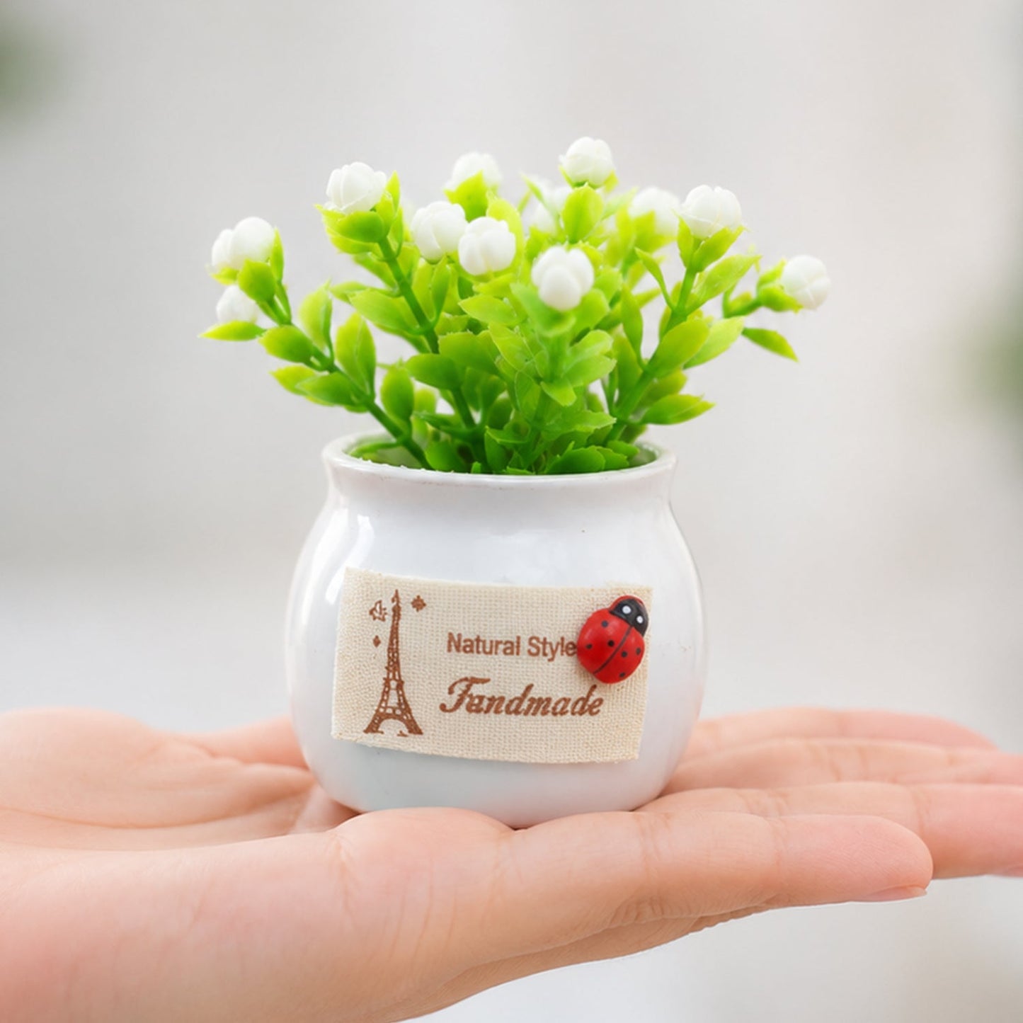 Mini artificial white flower bonsai plant in a ceramic pot, perfect for home decor, by Wukusy.