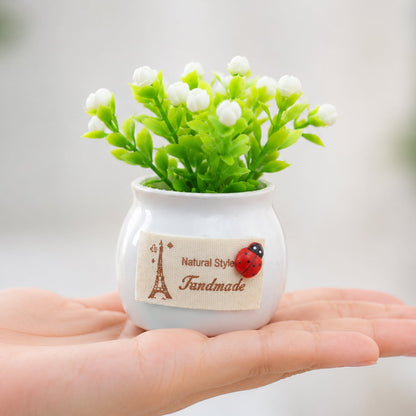 Mini artificial white flower bonsai plant in a ceramic pot, perfect for home decor, by Wukusy.
