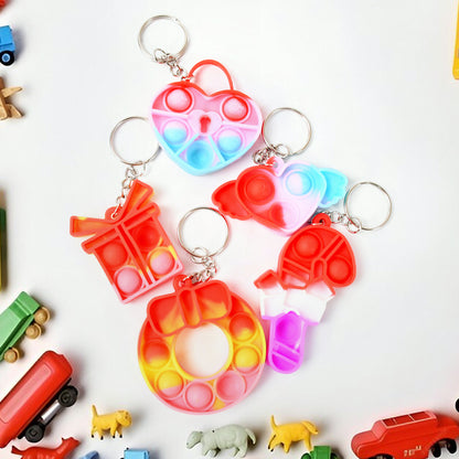 Wukusy Compact Silicone Pop It keychain toy with colorful bubble design, portable fidget stress relief toy for kids and birthdays