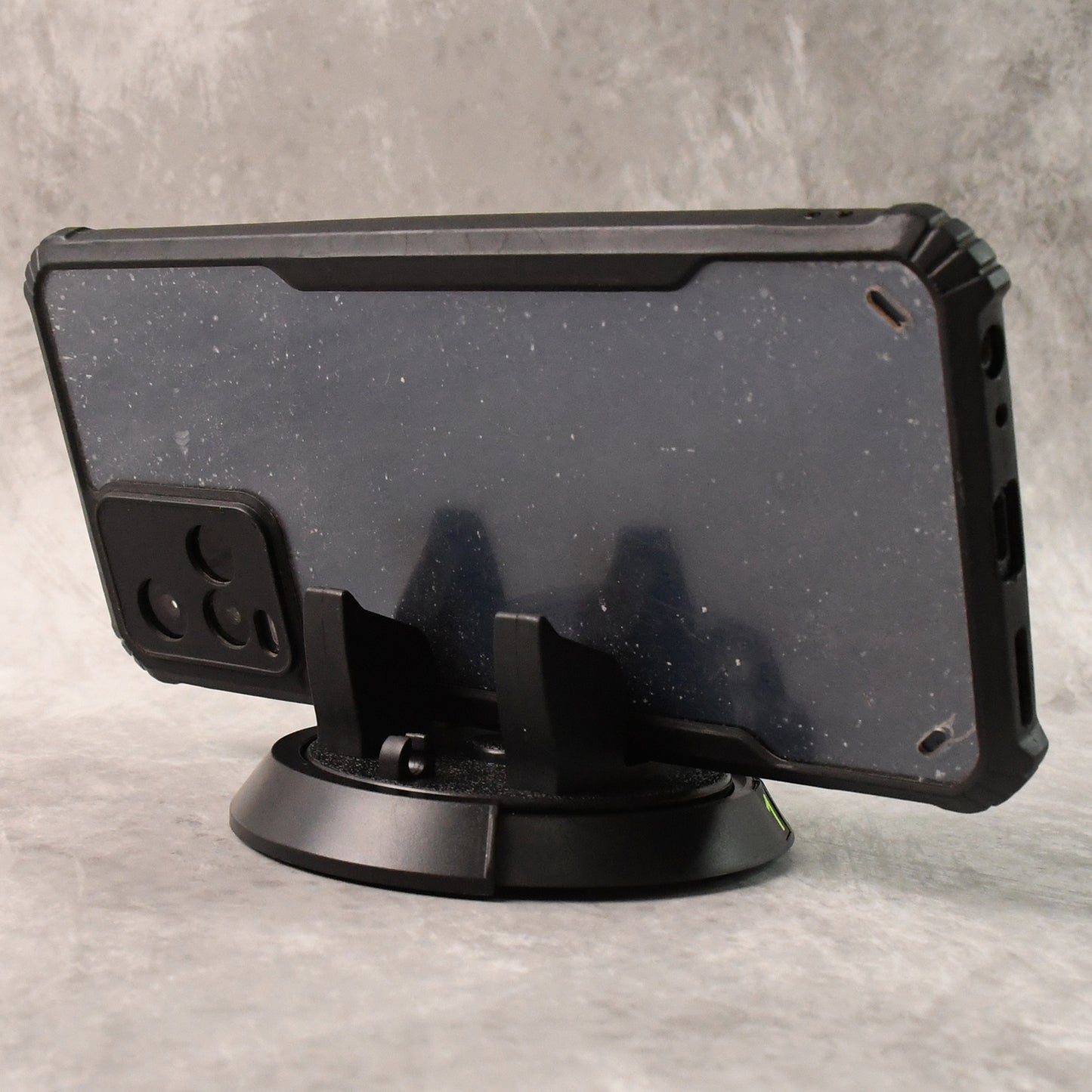 Wukusy multipurpose car dashboard mobile phone holder stand mounted on car dashboard with phone securely in place.