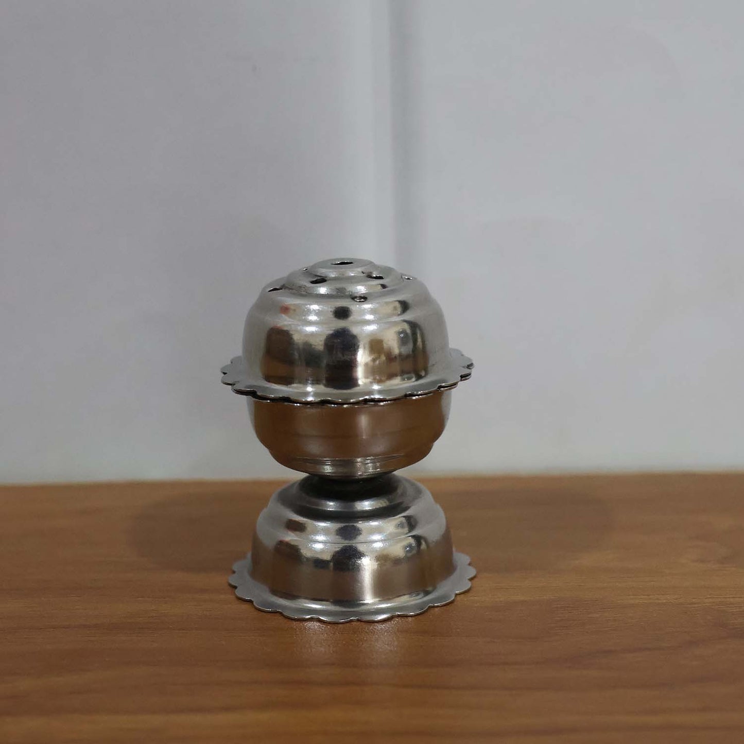 Stainless steel Jasmine Agarbatti stand by Wukusy holding incense sticks, with a sleek, polished design for aromatic incense burning.