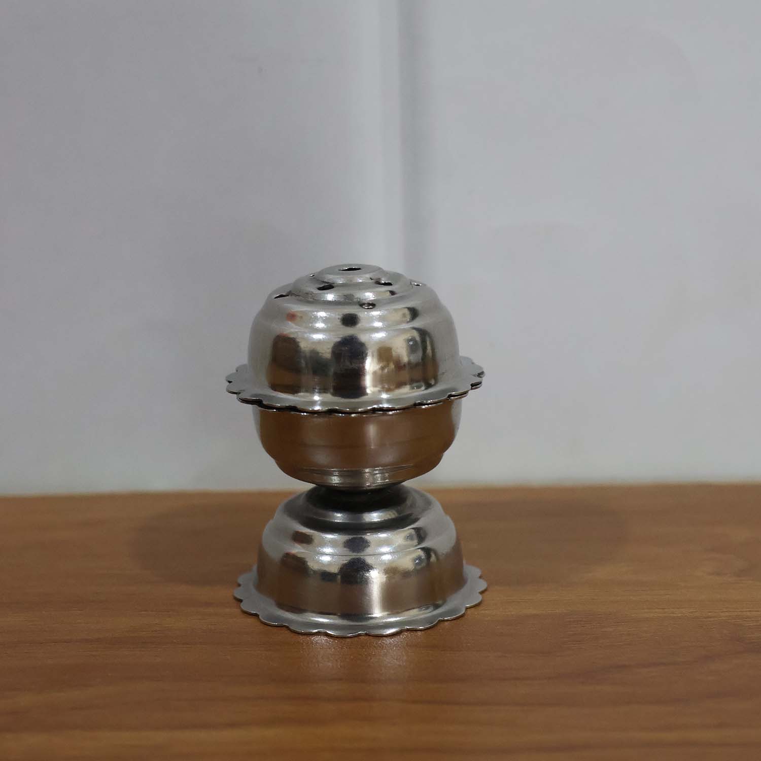 Stainless steel Jasmine Agarbatti stand by Wukusy holding incense sticks, with a sleek, polished design for aromatic incense burning.