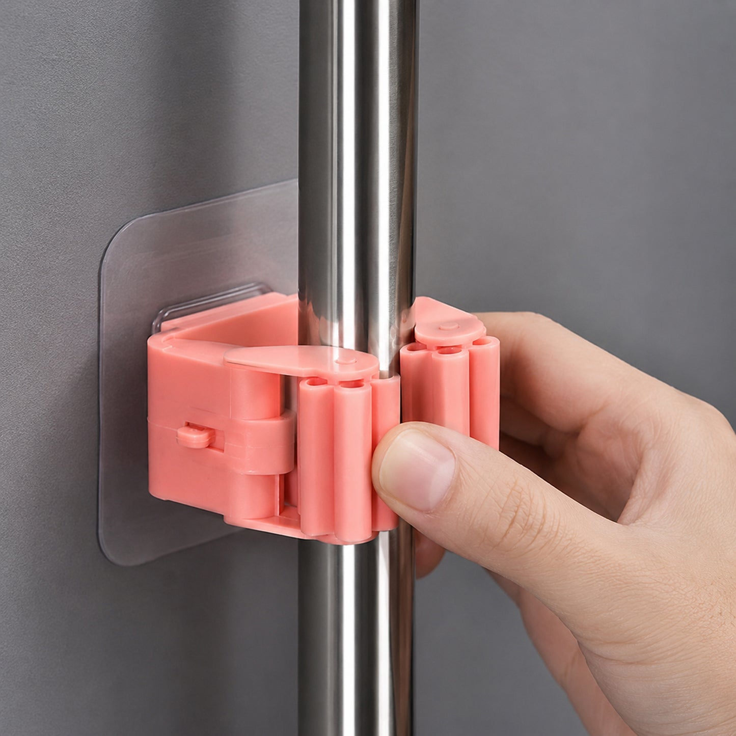 Wukusy plastic wall-mounted broom holder clip for mop storage, featuring one durable organizer with slots for cleaning tools.