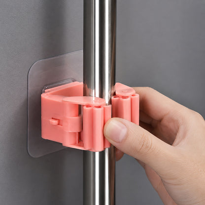 Wukusy plastic wall-mounted broom holder clip for mop storage, featuring one durable organizer with slots for cleaning tools.