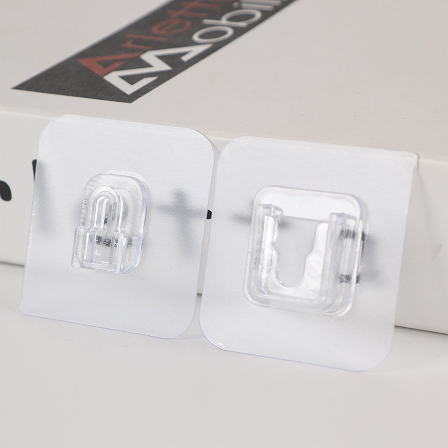 Pair of Wukusy heavy-duty adhesive plastic wall hooks for hanging items, shown mounted on a wall in the image.