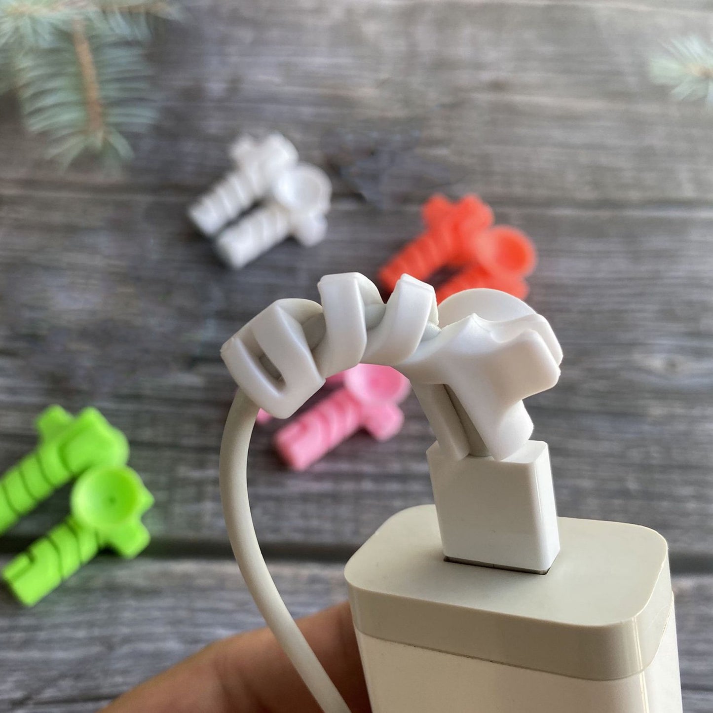 Set of four Wukusy cable cord protectors with suction ends, designed to prevent cable damage and keep cords organized.