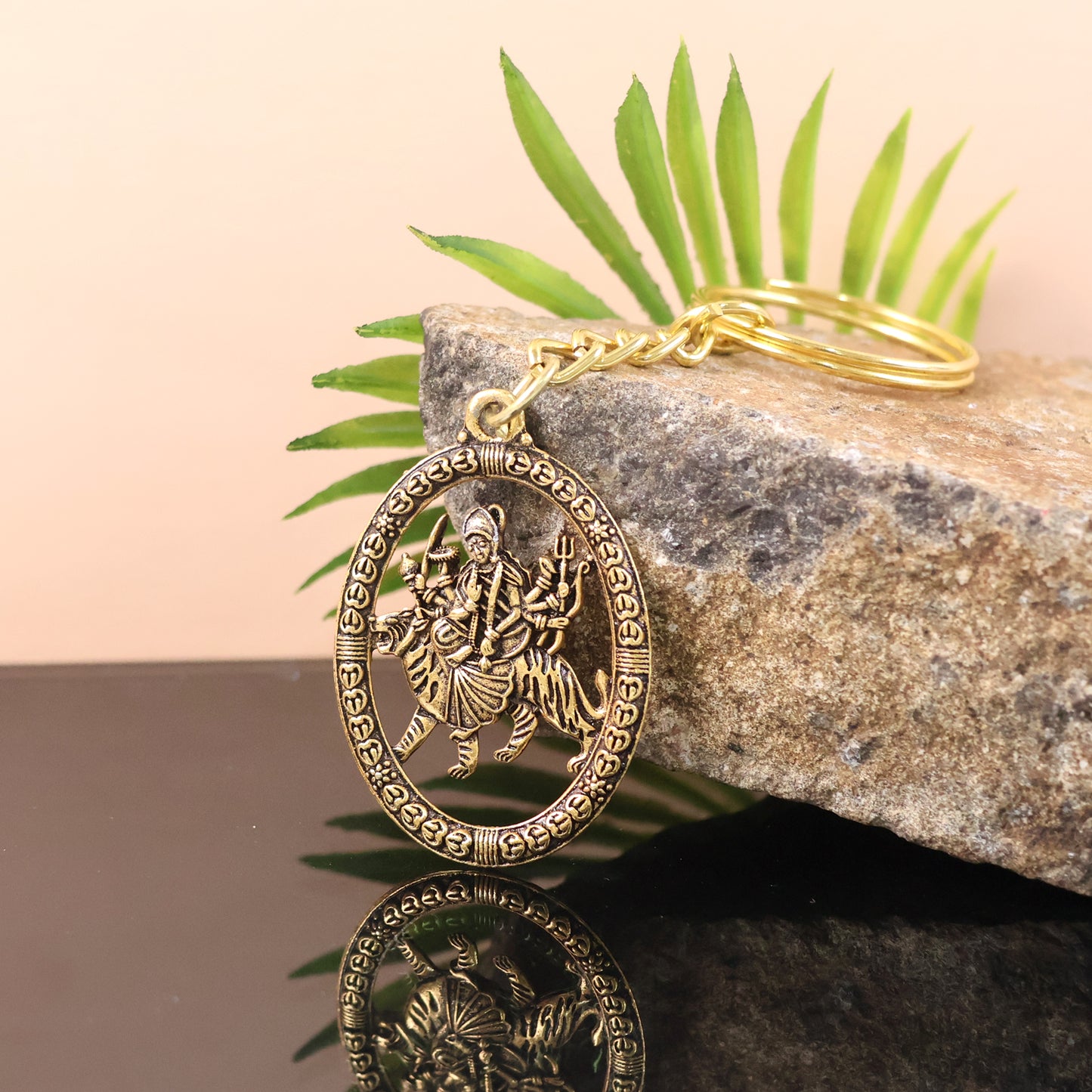 Golden metal Durga Maa keychain by Wukusy, showcasing intricate design on a durable accessory for keys or bags.