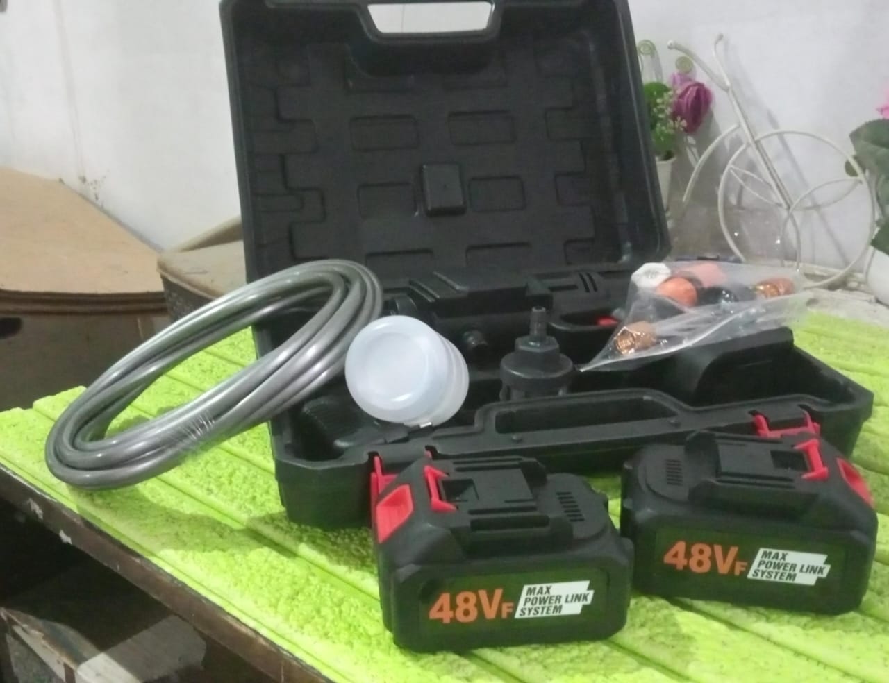 Wukusy 48V rechargeable electric car washer gun with double batteries, compact automotive cleaning tool for thorough vehicle washing.